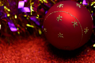Red christmas decorations on red shiny background. Christmas background