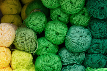 Shelf in a store with multi-colored skeins of yarn. Woolen, acrylic, silk thread. Knitting and...