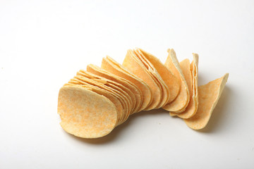 a pile of potato chips on white background