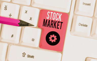 Handwriting text Stock Market. Conceptual photo traders buy and sell shares of companies on a public exchange White pc keyboard with empty note paper above white background key copy space