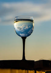 sunset reflection at the glass of water