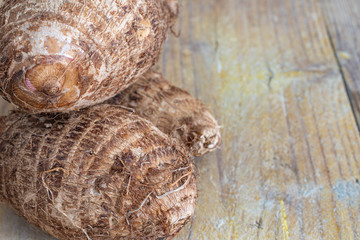 Top view of malangas on weathered wood background