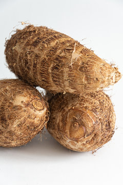 Close-up of brown malangas on white background in vertical