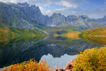  lake and rocks  a beautiful golden autumn in the area of ​​the town of Nusfjord, Norway, Lofoten Islands,