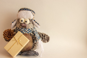 Christmas background with empty space. Toy snowman in a winter hat with gifts. Happy new year card.