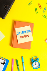 Word writing text Live Life On Your Own Terms. Business photo showcasing Give yourself guidelines for a good living Flat lay above table with copy space paper clips clock and pencils