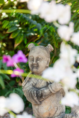 Fototapeta na wymiar smiling buddhist monk sculpture in garden