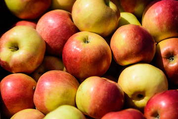 Group of fresh red apples available for sale at a street food market, natural background, soft focus