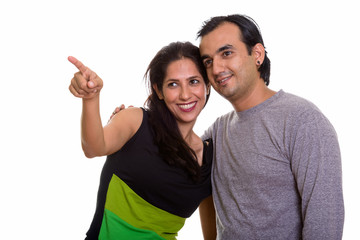 Obraz premium Happy Persian couple smiling and looking at distance together wi
