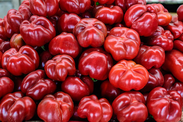 Group of fresh red peppers, available for sale at a street food market, natural background, soft focus