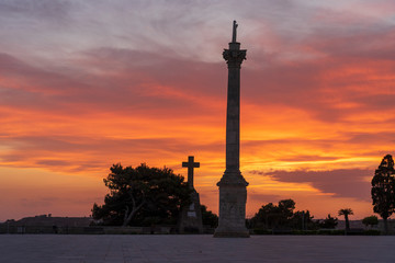 Fototapeta premium Sunset at Santa Maria di Leuca. Santa Maria di Leuca, Colonna Corinzia - Salento, Lecce, Apulia, Italy . Religious symbol, crucifix, cross - Immagine