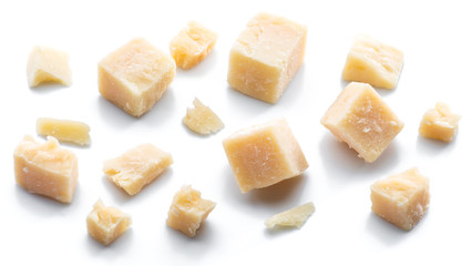 Parmesan cheese cubes and parmesan crumbs isolated on white background.