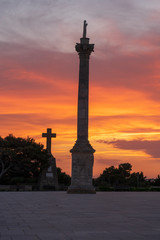 Fototapeta na wymiar Sunset at Santa Maria di Leuca. Santa Maria di Leuca, Colonna Corinzia - Salento, Lecce, Apulia, Italy . Religious symbol, crucifix, cross - Immagine