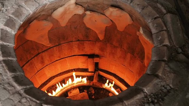 Traditional Bakery Tone or Torne or Turne for Baking a Georgian Shotis Puri or Shoti Bread. Cooking Process: Baker Shapes the Flat Bread and Sticking Dough to Wall of Oven and Taking Ready Shoti in