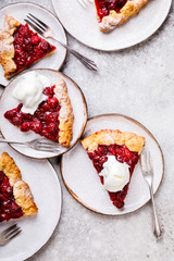 Bakery products. Summer pie with berries. Galeta with cherries sprinkled with powdered sugar.