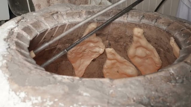Traditional Bakery Tone or Torne or Turne for Baking a Georgian Shotis Puri or Shoti Bread. Cooking Process: Baker Shapes the Flat Bread and Sticking Dough to Wall of Oven and Taking Ready Shoti in