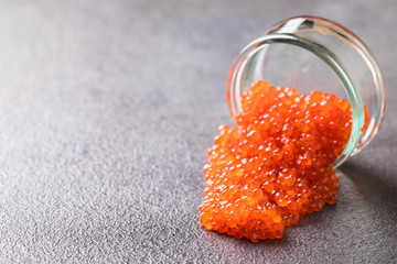 Salmon  Red Caviar in a white plate on a dark background. Healthy Food Concept. Snack.Copy space for Text.Seafood.