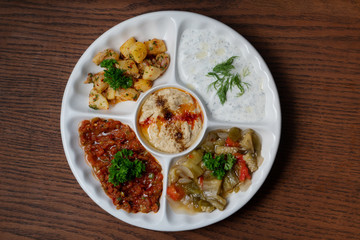 Mix plate arabic food with vegetarian spread starters isolated on wooden background