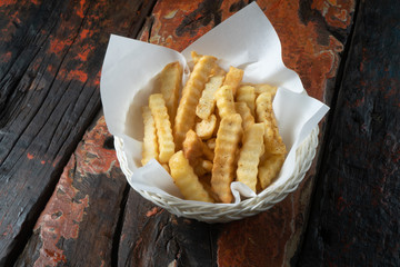 French fries isolated on rustic wooden table