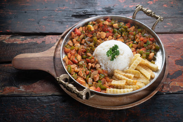 Turkish food lamb meat saute, sac kavurma with rice and french fries isolated on rustic wooden table