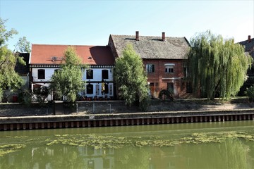Fototapeta na wymiar river along which old houses stand