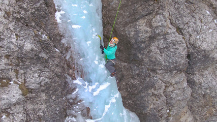 CLOSE UP: Extreme ice climber scales up the frozen waterfall in the Julian Alps.