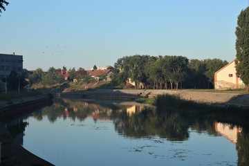 Fototapeta premium river along which old houses stand
