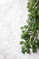 Fototapeta premium Traditional Christmas and New Year decor in the form Christmas tree branches.Holiday decoration on a snowy background.Copy space