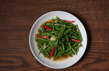 Top view Thai food stir fried morning glory isolated on wooden table