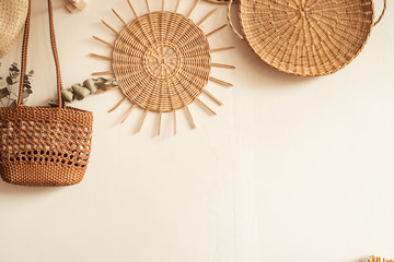 Light concrete wall, round rattan wicker panel. Plate of vines. home or apartment decoration. handmade art in the form of weaving from a rod. Flat lay,top view, copy space.