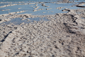 Lonely man walks along the path through the Dead sea from Israel to Jordan cross the border