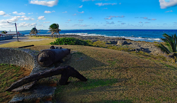 An old rusty cannon on the edge of coastline in Le Moule town in Guadeloupe, Grande-Terre island, french West Indies