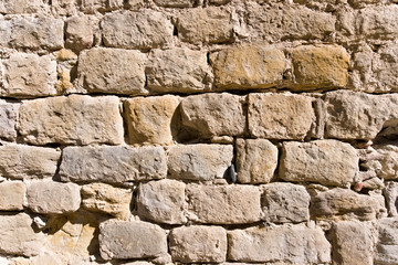 Yellow grey brickwall in sunlight