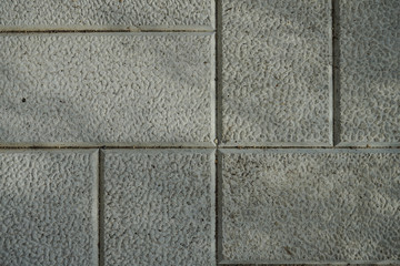 The texture of cement floor tiles. Rough surface with particles of sand and debris.