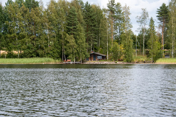 Lake Hallanlahti summer view with reflection of clouds on water .