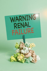 Text sign showing Warning Renal Failure. Business photo text stop Filtering Excess Waste Acute Kidney malfunction Reminder pile colored crumpled paper clothespin reminder blue background