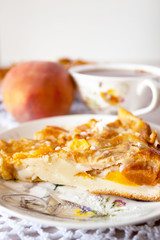 Homemade fruit apple apricot peach pie on white crochet napkin on white rustic table background