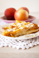 Homemade fruit apple apricot peach pie on white crochet napkin on white rustic table background