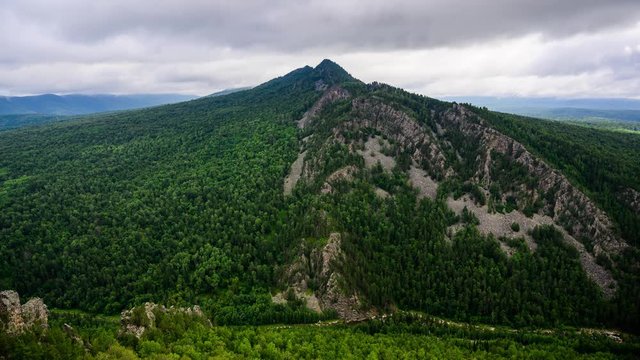 Timelapse of sun bunnies running along the mountain