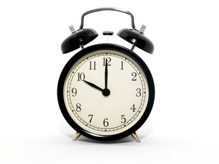 Old-style alarm clock, black and white, it's ten o'clock.