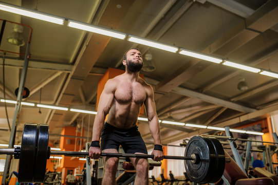 close up photo of a man lifting weights at the gym