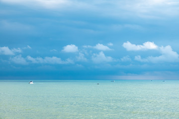 Fototapeta na wymiar Blue sea and several boats on a cloudy day
