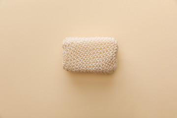 top view of natural bath sponge on beige background