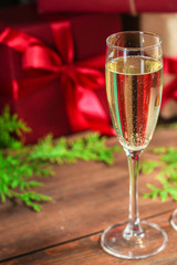 champagne and new year, christmas or noel (champagne glass, sparkling wine and gifts on the table) menu concept. food background. copy space. Top view