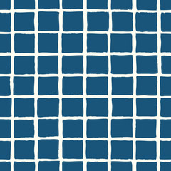 Hand painted seamless pattern with a grid in blue on cream background.