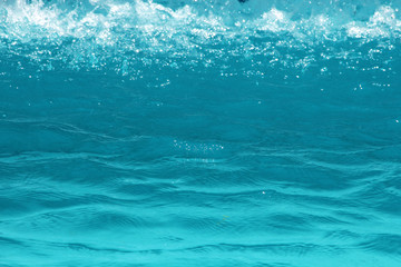 Blue pool water reflecting sun rippled details.surface of blue pool, bottom of water in swimming pool