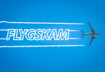 Airplane leaving jet contrails with Flygskam word inside.Flygskam or flight shame in Swedish refers...