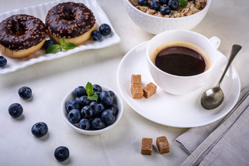 Breakfast with coffee and baking on light background