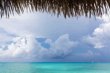 A beach on an island, and view over turquoise sea.