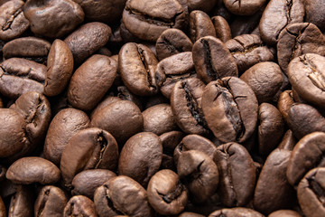 Roasted coffee beans background. Cappuccino, aroma black caffeine drink ingredient